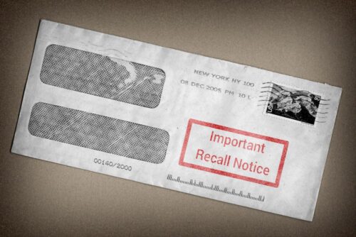 An envelope with two address windows and a red stamp labeled "Important Recall Notice," possibly hinting at past mistakes. It has a postmark from New York and a stamp featuring an ocean wave design, as if to wash away worries of road mishaps.