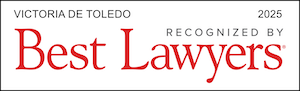 A plaque showcasing "Victoria de Toledo 2025, Celebrated by Best Lawyers" elegantly in striking red and black font.
